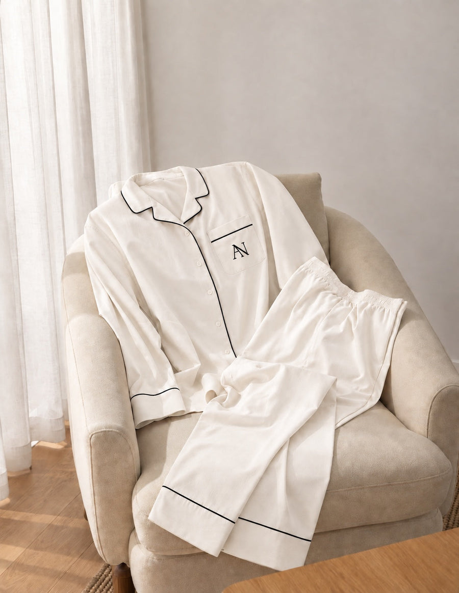 Bamboo Long Pyjama Set in Pearl. Complete set with black piping and the AN pocket monogram.