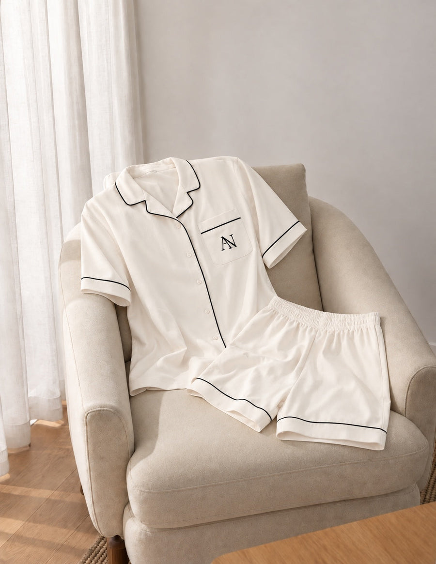 Bamboo Short Pyjama Set in Pearl. Complete set with black piping and the AN pocket monogram.